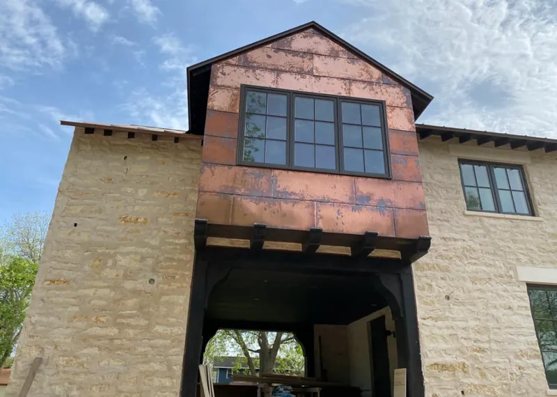 Copper metal panel facade on a stone building for Skylight Installation in Easley